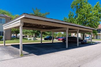 a covered parking lot with cars parked in it